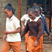 Children at a Waldorf school in Kenya run out of the school building.